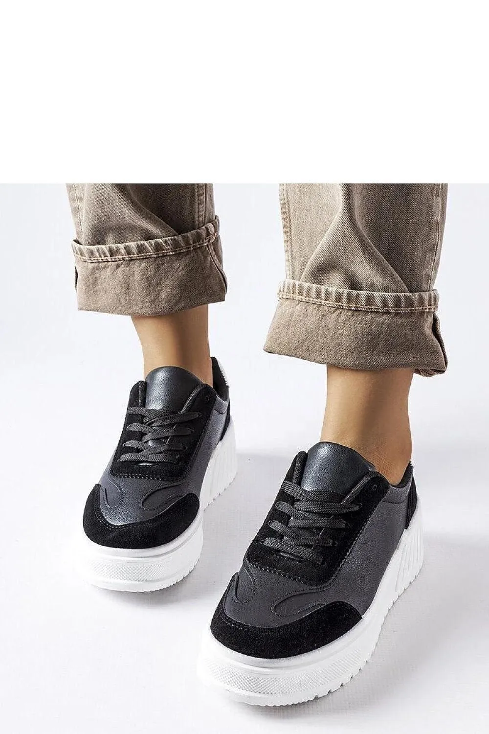 Black sneakers on a thick Seluci platform