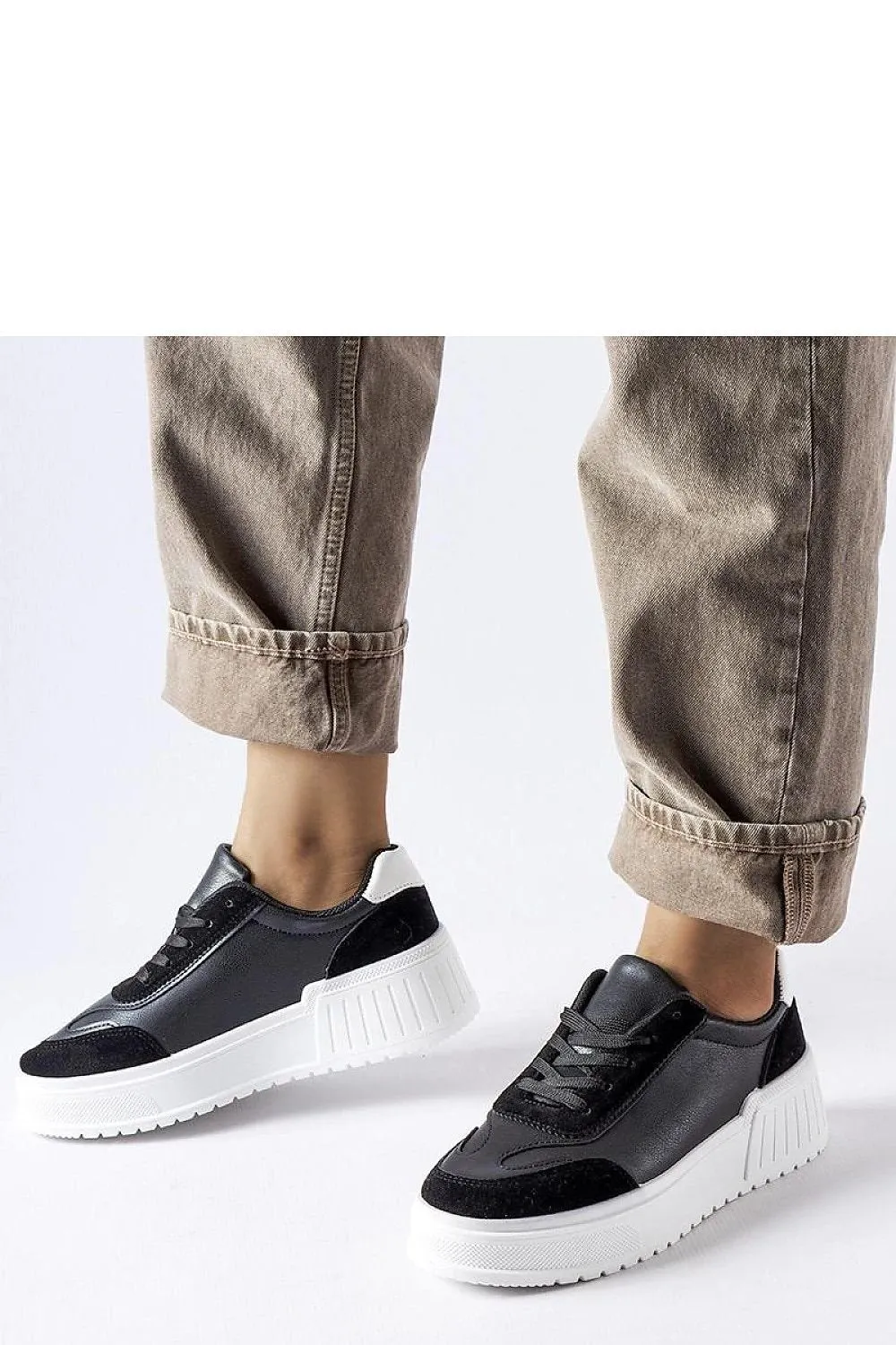 Black sneakers on a thick Seluci platform
